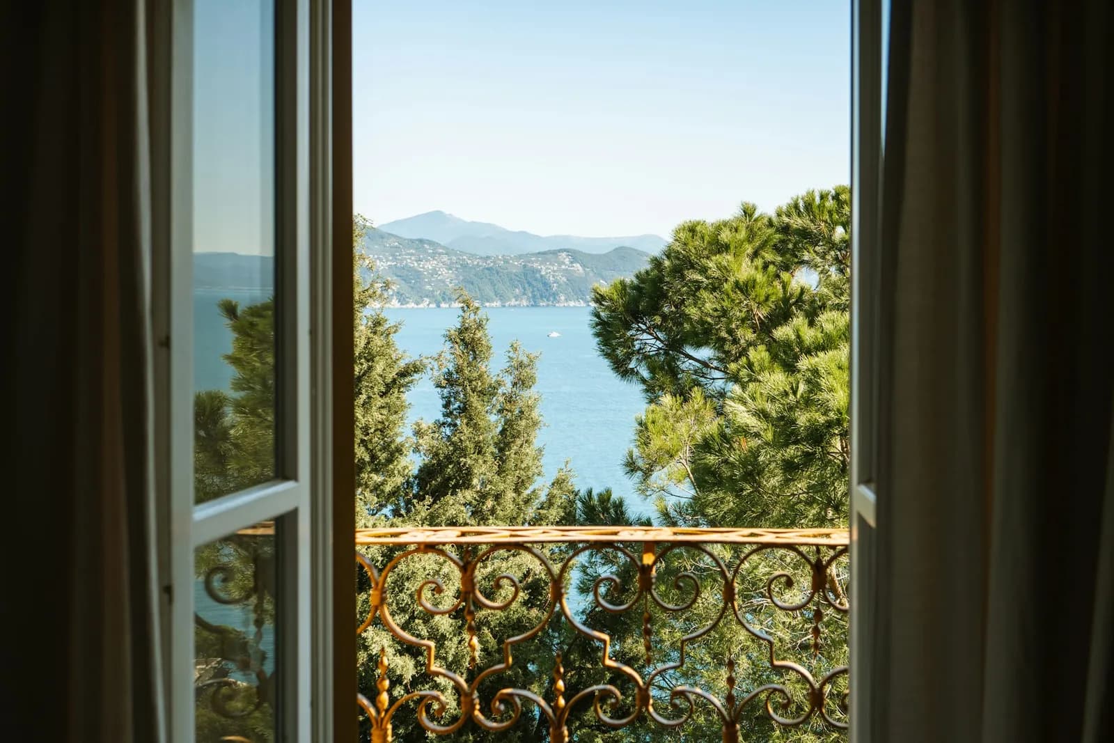 Offenes Fenster mit Blick auf Bäume und einen See